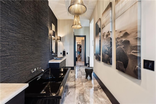 corridor with marble tiled floors and baseboards