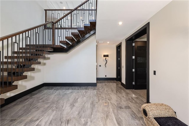 stairway featuring baseboards
