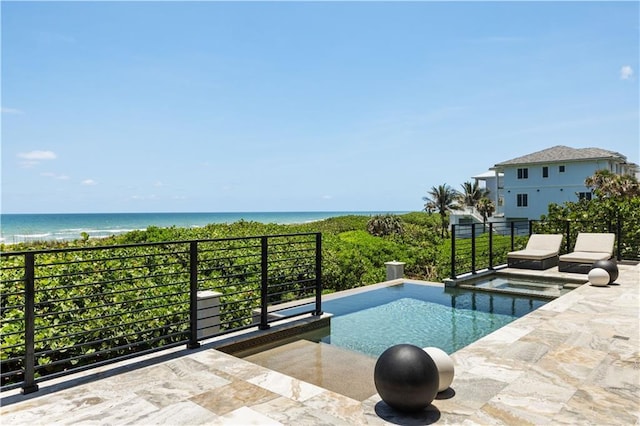 view of pool featuring a water view and a pool with connected hot tub