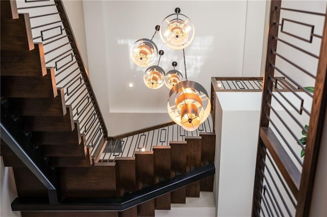 stairway with a chandelier