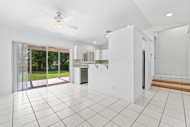 22 Pepperwood Ct, Boynton Beach, FL 33426 - kitchen with dishwasher, ceiling fan, light countertops, white cabinetry, and light tile patterned floors