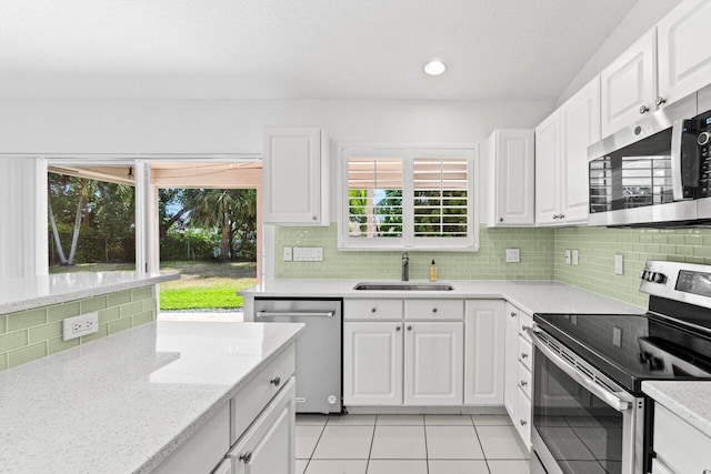 22 Pepperwood Ct, Boynton Beach, FL 33426 - kitchen with appliances with stainless steel finishes, a sink, light tile patterned floors, white cabinetry, and recessed lighting