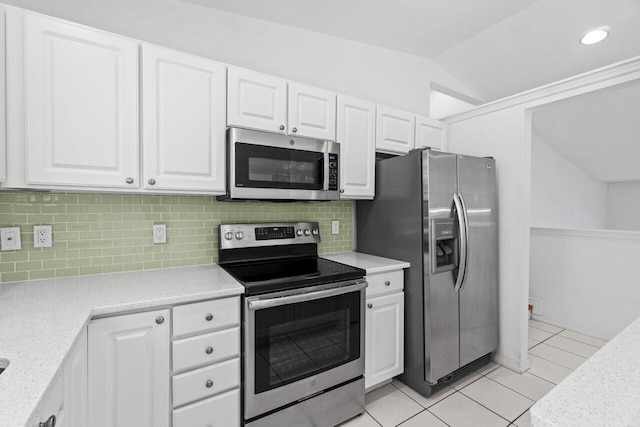 22 Pepperwood Ct, Boynton Beach, FL 33426 - kitchen featuring appliances with stainless steel finishes, vaulted ceiling, white cabinets, light countertops, and light tile patterned flooring