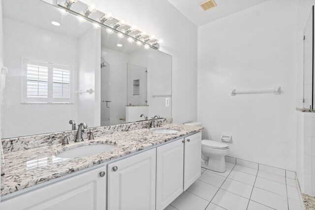 22 Pepperwood Ct, Boynton Beach, FL 33426 - bathroom featuring a stall shower, toilet, double vanity, and tile patterned floors