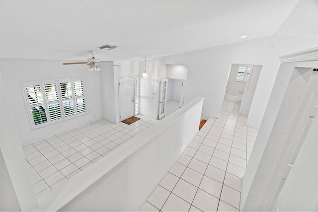 22 Pepperwood Ct, Boynton Beach, FL 33426 - spare room featuring light tile patterned flooring, a ceiling fan, vaulted ceiling, and a textured ceiling