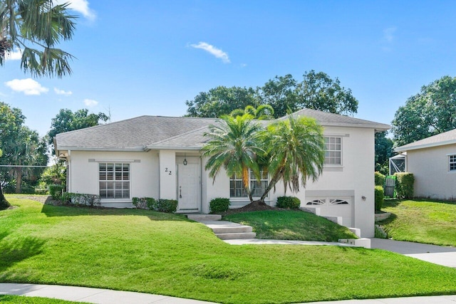 22 Pepperwood Ct, Boynton Beach, FL 33426 - view of front of house with an attached garage, stucco siding, a front lawn, and driveway
