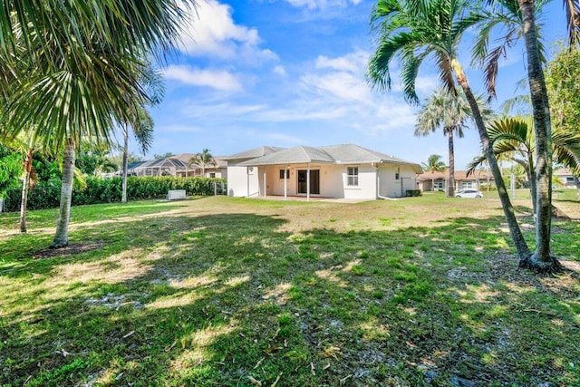 22 Pepperwood Ct, Boynton Beach, FL 33426 - rear view of property with a patio, a lawn, and stucco siding