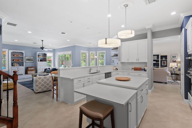 7668 SE Laque Cir, Stuart, FL 34997 - kitchen with open floor plan, dishwasher, a peninsula, a sink, and light tile patterned flooring