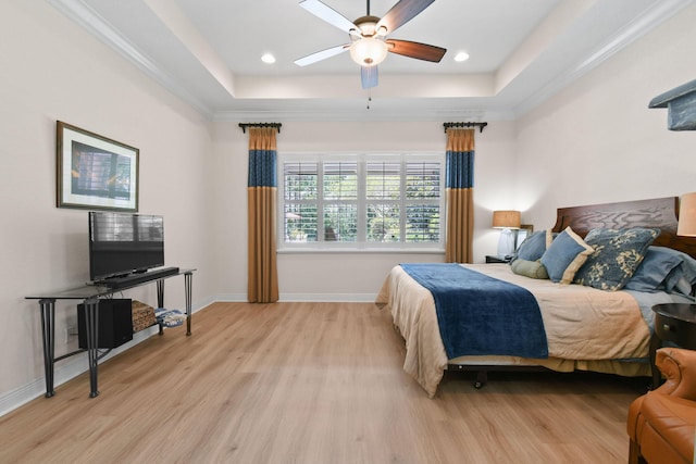 7668 SE Laque Cir, Stuart, FL 34997 - bedroom with a raised ceiling, light wood-style flooring, baseboards, a ceiling fan, and recessed lighting