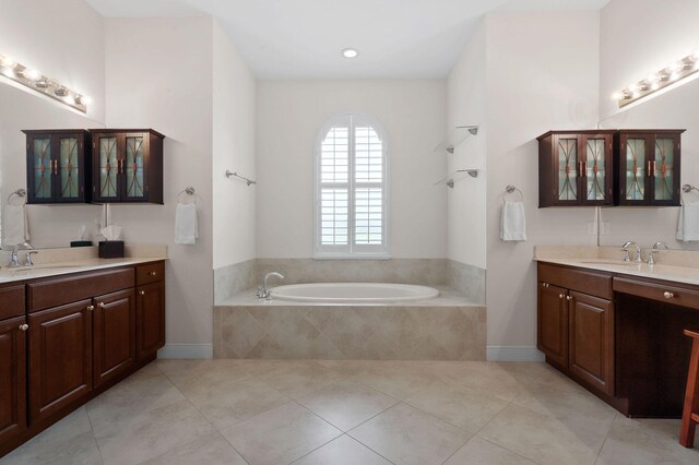 7668 SE Laque Cir, Stuart, FL 34997 - bathroom with tile patterned flooring, a bath, and two vanities