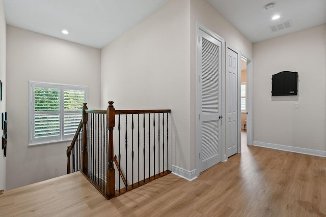 7668 SE Laque Cir, Stuart, FL 34997 - hall featuring an upstairs landing, light wood-style floors, baseboards, and recessed lighting
