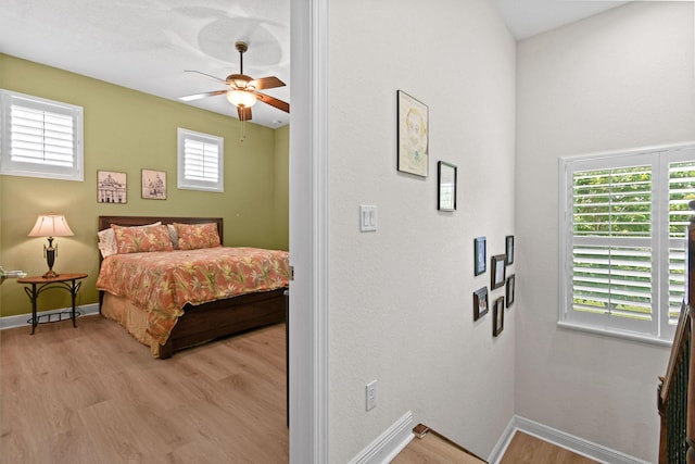 7668 SE Laque Cir, Stuart, FL 34997 - bedroom featuring light wood-type flooring, multiple windows, and baseboards