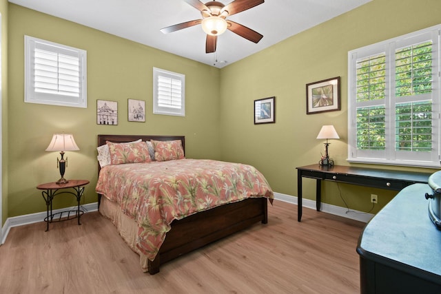 7668 SE Laque Cir, Stuart, FL 34997 - bedroom featuring light wood-type flooring, baseboards, and a ceiling fan