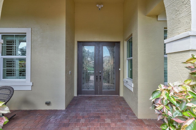 7668 SE Laque Cir, Stuart, FL 34997 - view of exterior entry with french doors and stucco siding