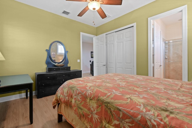 7668 SE Laque Cir, Stuart, FL 34997 - bedroom featuring wood finished floors, a closet, a ceiling fan, and baseboards