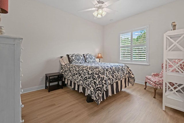 7668 SE Laque Cir, Stuart, FL 34997 - bedroom with wood finished floors, baseboards, and a ceiling fan