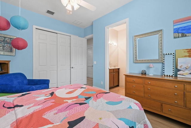 7668 SE Laque Cir, Stuart, FL 34997 - bedroom featuring a closet, light wood-style floors, ensuite bathroom, and ceiling fan