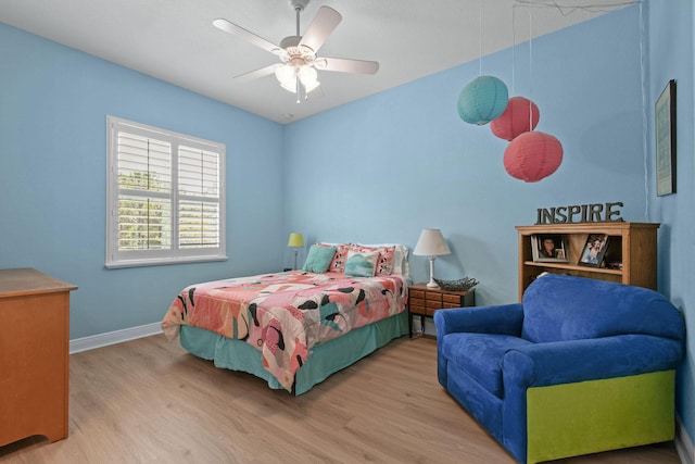 7668 SE Laque Cir, Stuart, FL 34997 - bedroom with wood finished floors, baseboards, and a ceiling fan