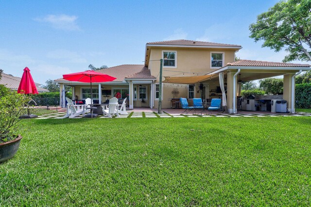 7668 SE Laque Cir, Stuart, FL 34997 - back of property featuring a tile roof, ceiling fan, a patio area, and stucco siding