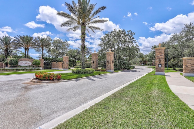 7668 SE Laque Cir, Stuart, FL 34997 - view of asphalt street featuring curbs and a gated entry