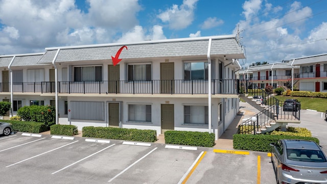 3160 Lake Osborne Dr Unit 211, Lake Worth Beach, FL 33461 - view of building exterior with uncovered parking