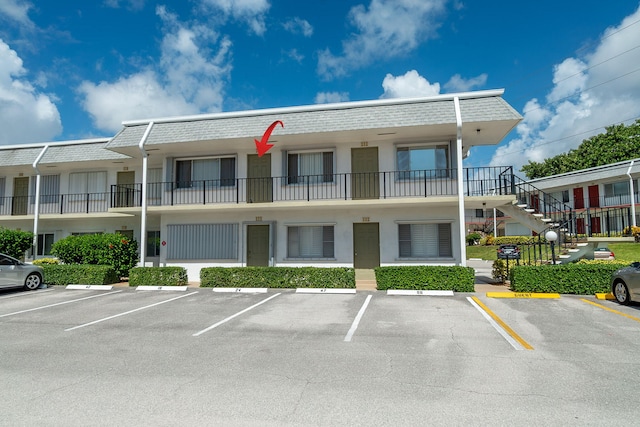 3160 Lake Osborne Dr Unit 211, Lake Worth Beach, FL 33461 - view of property with uncovered parking and stairs