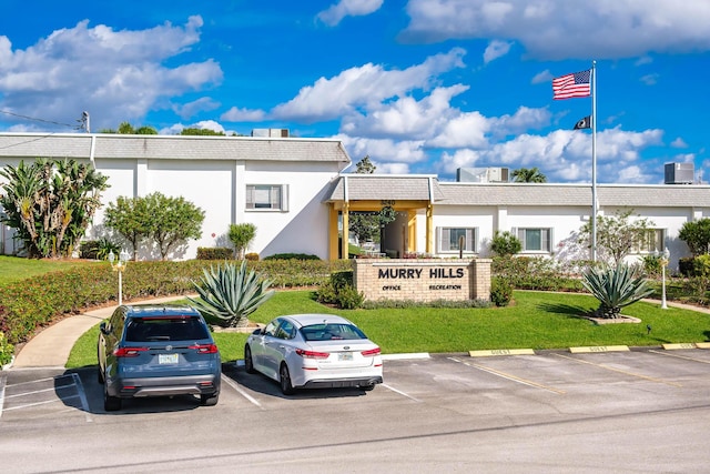 3160 Lake Osborne Dr Unit 211, Lake Worth Beach, FL 33461 - view of building exterior featuring uncovered parking and central AC unit