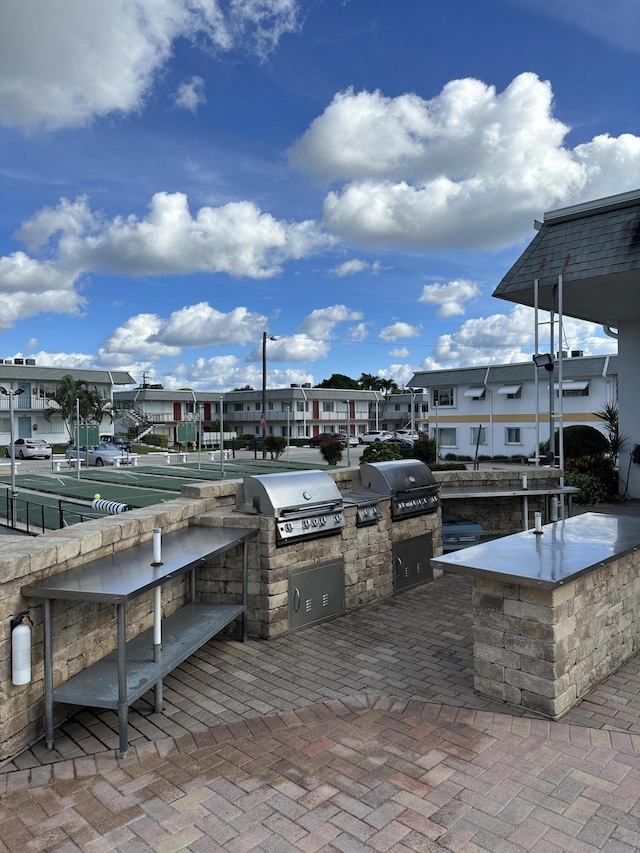 3160 Lake Osborne Dr Unit 211, Lake Worth Beach, FL 33461 - view of patio with area for grilling and a residential view