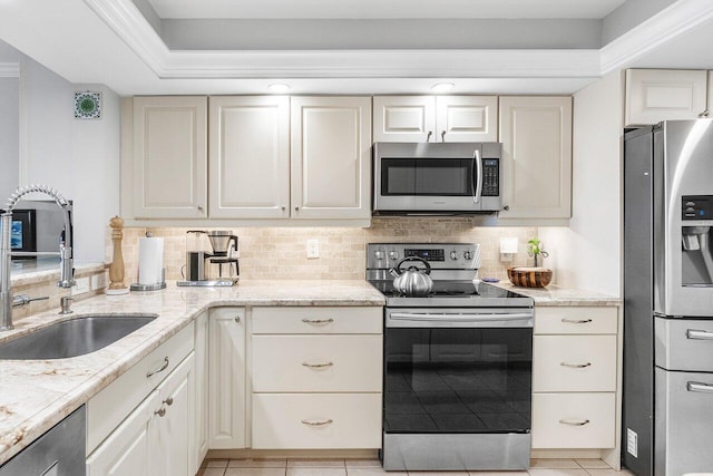 20 NE Plantation Rd Unit 203, Stuart, FL 34996 - kitchen featuring stainless steel appliances, a sink, tasteful backsplash, and light tile patterned floors