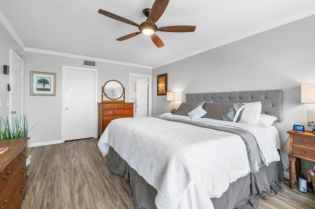 20 NE Plantation Rd Unit 203, Stuart, FL 34996 - bedroom with wood finished floors, ornamental molding, ceiling fan, and baseboards