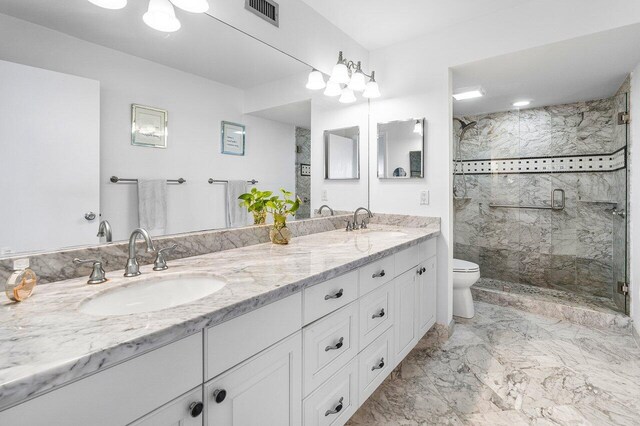 20 NE Plantation Rd Unit 203, Stuart, FL 34996 - full bath with a marble finish shower, toilet, double vanity, and marble finish floors