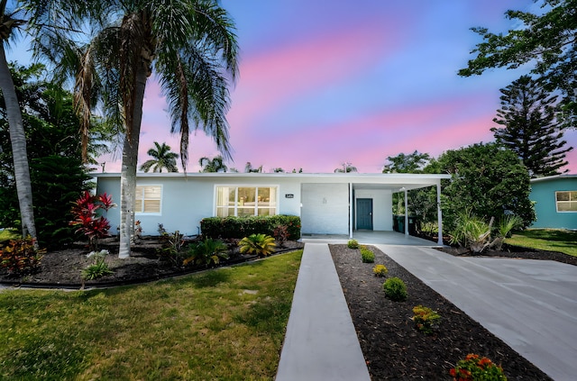 3056 SE Morningside Blvd, Port Saint Lucie, FL 34952 - single story home featuring concrete driveway, an attached carport, a lawn, and stucco siding