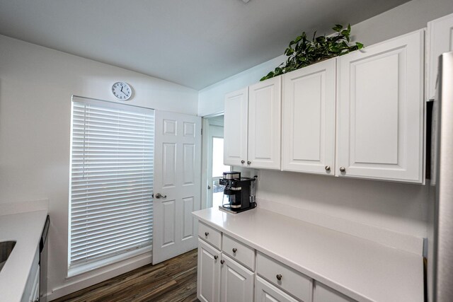 3056 SE Morningside Blvd, Port Saint Lucie, FL 34952 - kitchen with dark wood-style floors, white cabinetry, and light countertops