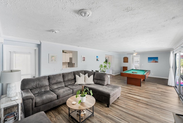 3056 SE Morningside Blvd, Port Saint Lucie, FL 34952 - living area with wood finished floors, a textured ceiling, billiards table, baseboards, and ornamental molding