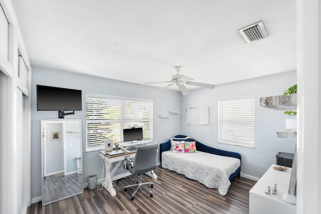 3056 SE Morningside Blvd, Port Saint Lucie, FL 34952 - bedroom featuring an office area, wood finished floors, baseboards, ceiling fan, and a closet