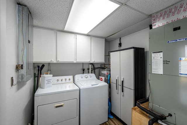 3056 SE Morningside Blvd, Port Saint Lucie, FL 34952 - laundry room with cabinet space, washing machine and dryer, heating unit, water heater, and light wood finished floors