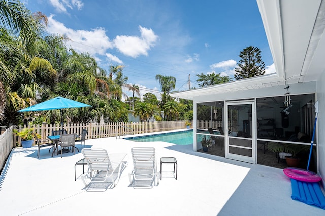 3056 SE Morningside Blvd, Port Saint Lucie, FL 34952 - view of pool featuring a patio, a fenced backyard, and a sunroom