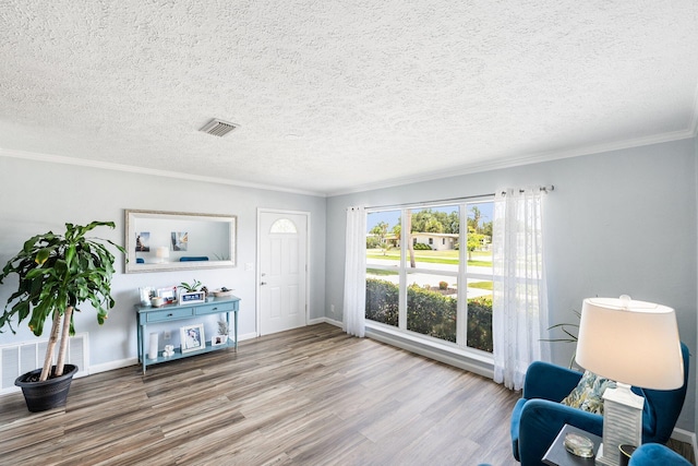3056 SE Morningside Blvd, Port Saint Lucie, FL 34952 - sitting room featuring wood finished floors, ornamental molding, baseboards, and a textured ceiling