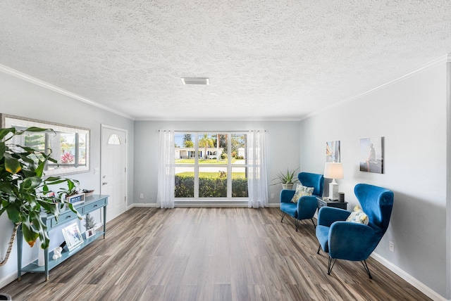 3056 SE Morningside Blvd, Port Saint Lucie, FL 34952 - sitting room featuring wood finished floors, baseboards, crown molding, and a textured ceiling