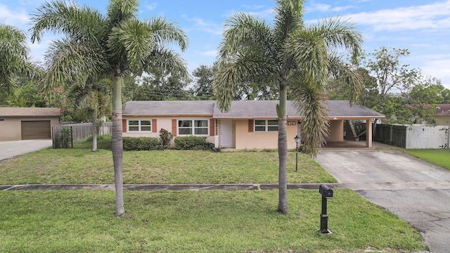 ranch-style home with concrete driveway, an attached carport, and brick siding