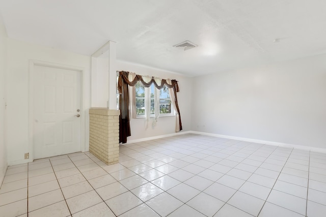 unfurnished room featuring light tile patterned floors and baseboards