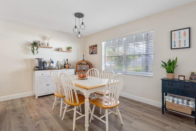dining area featuring baseboards and light wood-style floors