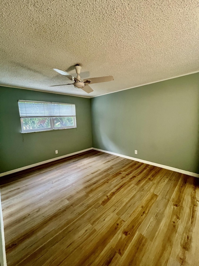 2601 NE 3rd Ct Unit 2040, Boynton Beach, FL 33435 - spare room featuring a textured ceiling, a ceiling fan, wood finished floors, and baseboards