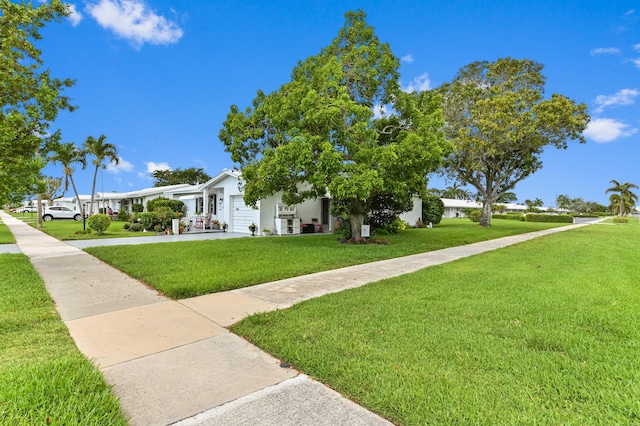 103 SW 18th St, Boynton Beach, FL 33426 - view of front facade with a front lawn and a garage