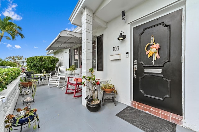 103 SW 18th St, Boynton Beach, FL 33426 - property entrance with a porch and stucco siding