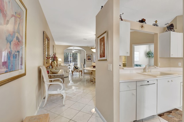 9620 Crescent View Dr N, Boynton Beach, FL 33437 - kitchen featuring dishwasher, a sink, arched walkways, light countertops, and light tile patterned floors