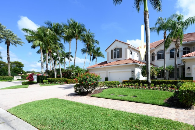112 Palm Bay A Dr Unit A, Palm Beach Gardens, FL 33418 - view of front of property with driveway, a garage, a front lawn, a tiled roof, and stucco siding