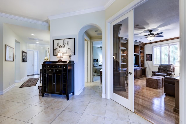 112 Palm Bay A Dr Unit A, Palm Beach Gardens, FL 33418 - corridor with ornamental molding, arched walkways, baseboards, and light tile patterned floors