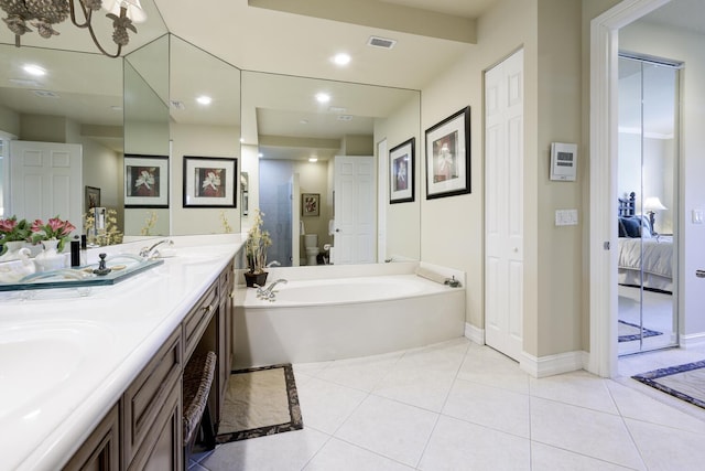 112 Palm Bay A Dr Unit A, Palm Beach Gardens, FL 33418 - ensuite bathroom with double vanity, a bath, tile patterned flooring, baseboards, and recessed lighting