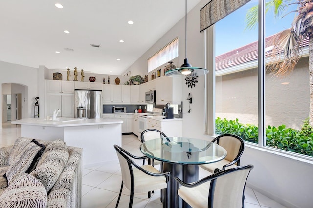 4498 Hazleton Ln, Lake Worth, FL 33449 - dining area featuring arched walkways, light tile patterned floors, and recessed lighting